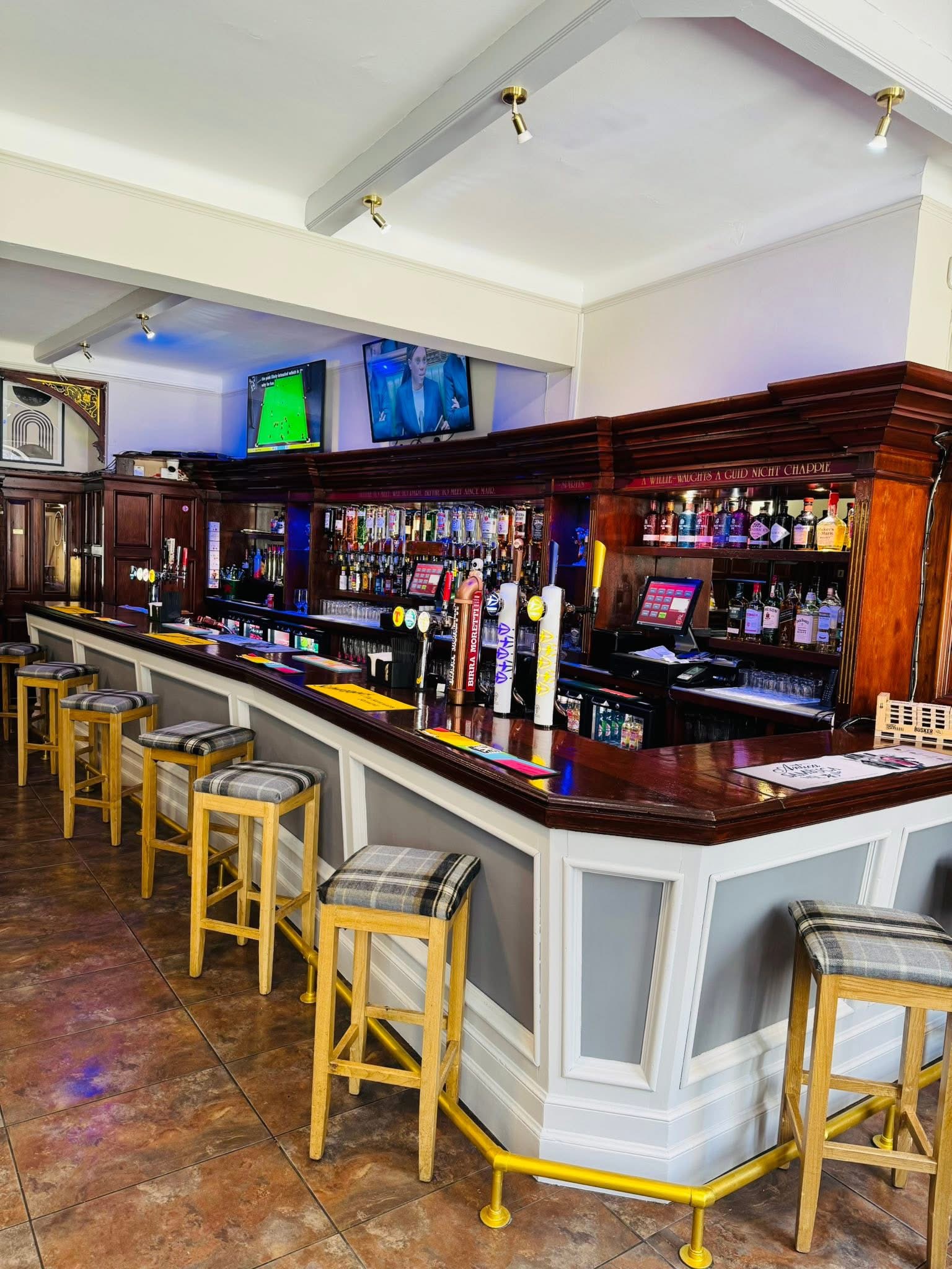 Dark wood bar with brass foot rail